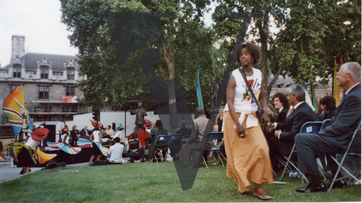 Parliament Square, carnival dancers, woman in shot, Brian May in attendance.