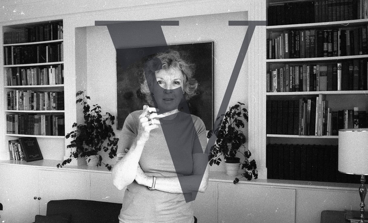 Martha Gellhorn, portrait, smoking cigarette, smiling.