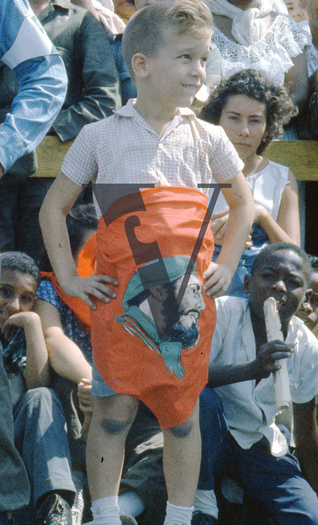 Cuba, Havana, May 1st Parade, boy wrapped in Castro flag.