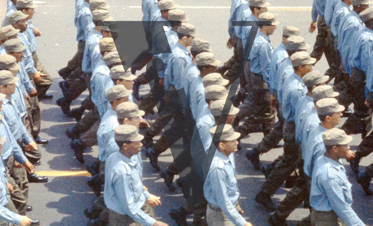 Cuba, Havana, May 1st Parade, men in blue uniform march.