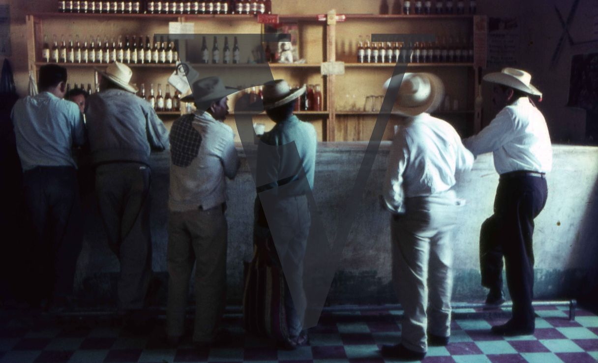 Mexico, Men in cowboy hats at bar.