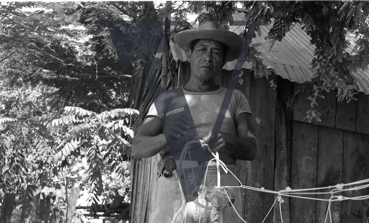 Mexico, Man fixing net, portrait.