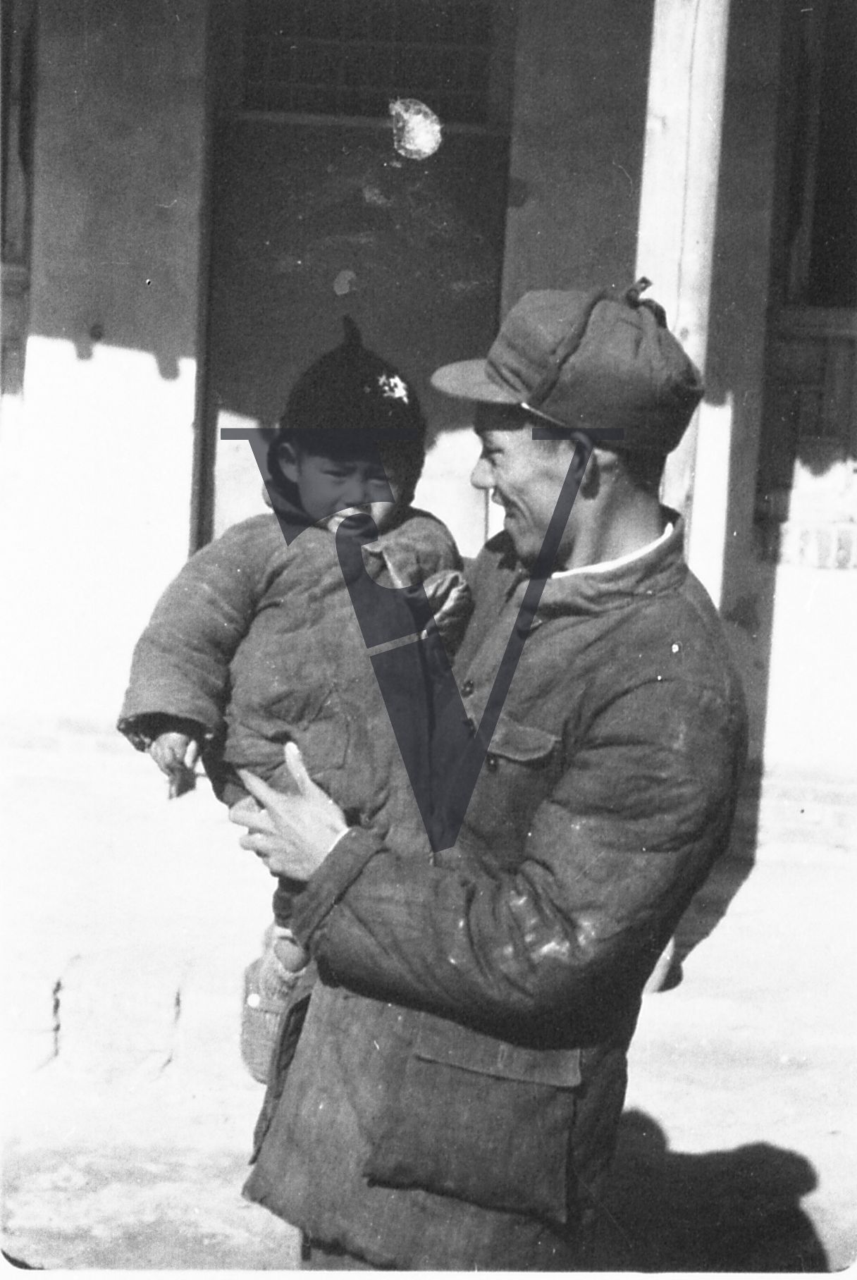 China, Yenan,  Chinese serviceman with small child.