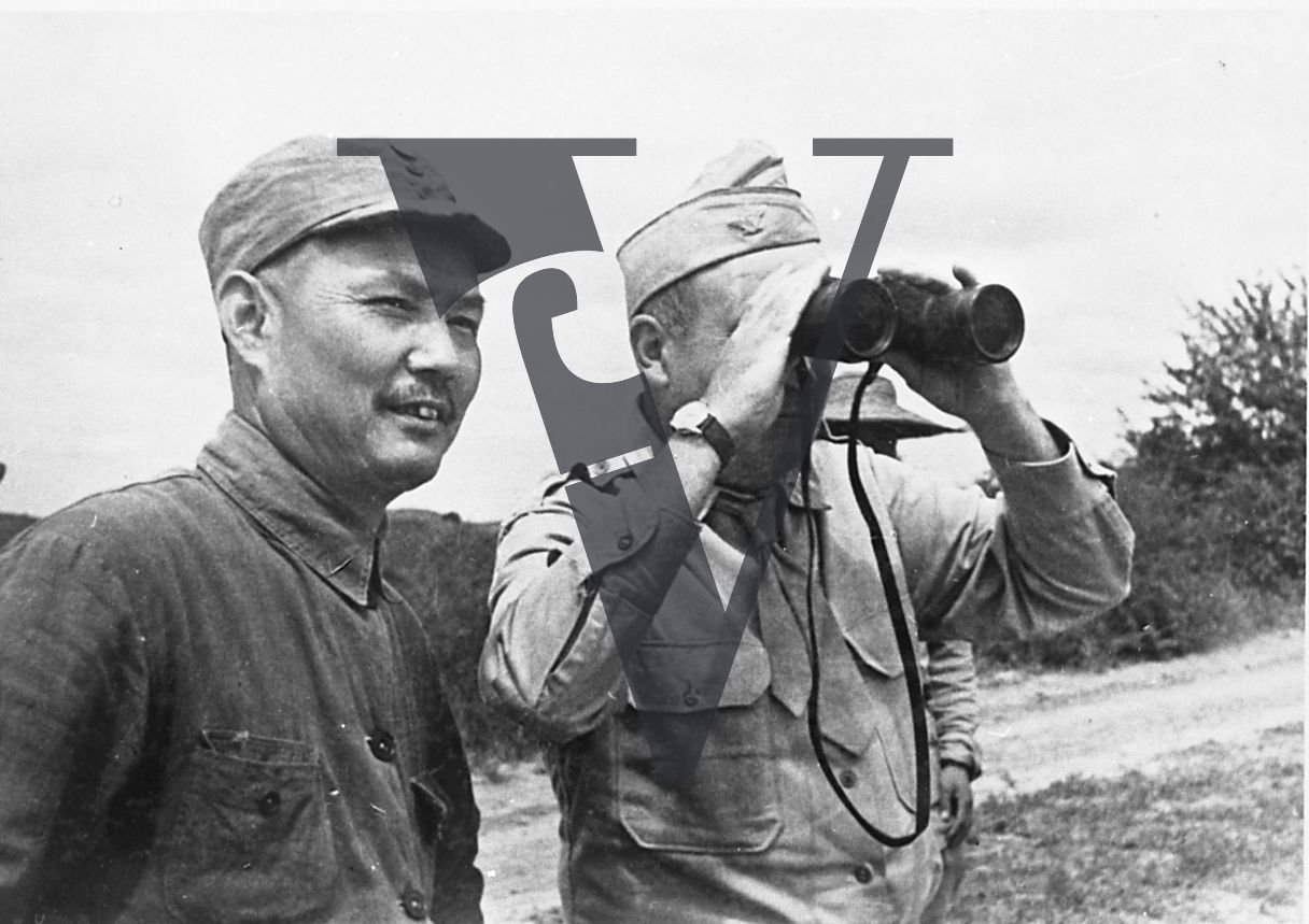 China, Yenan, Colonel David D. Barrett using binoculars, General Ye Jianying, mid shot.