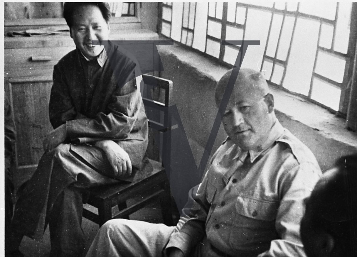 China, Yenan, Mao Zedong, smiling, Colonel David D. Barrett, seated, mid-shot.