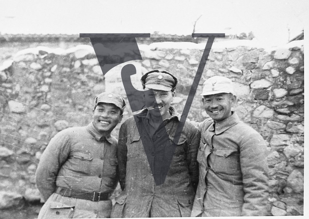 China Yenan, Raymond P. Ludden, two Chinese guerrillas, portrait, smiling, mid-shot.