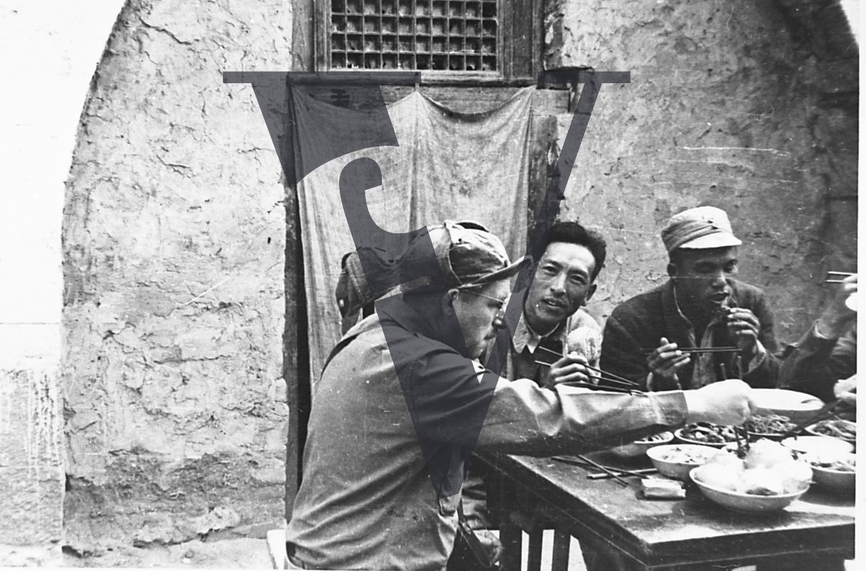 China Yenan, Wilbur J. Peterkin eating with Chinese guerrillas.