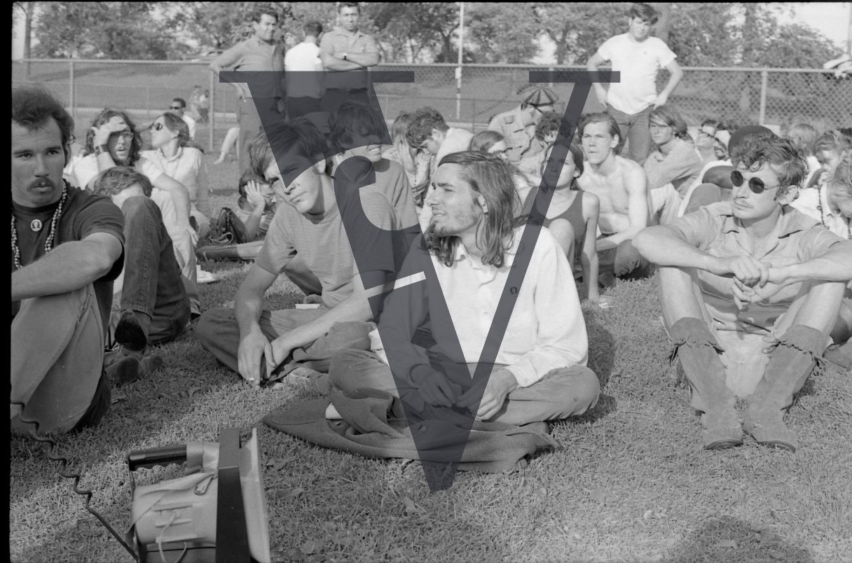 Chicago, Anti-war rallies in Lincoln Park, group of hippy youth sit crossed-leg.