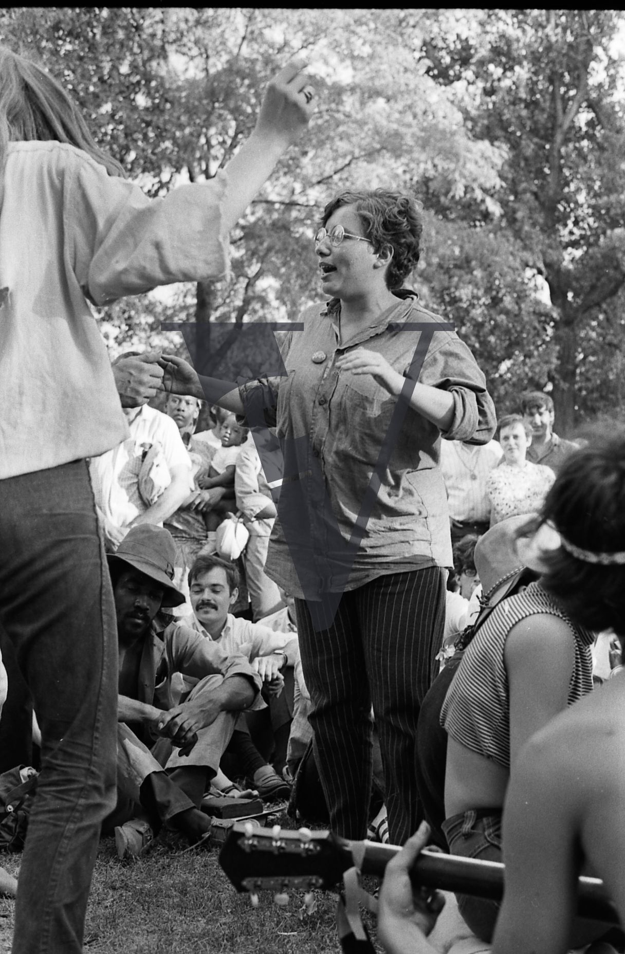 Chicago, Anti-war rallies in Lincoln Park, woman with glasses dances in crowd.