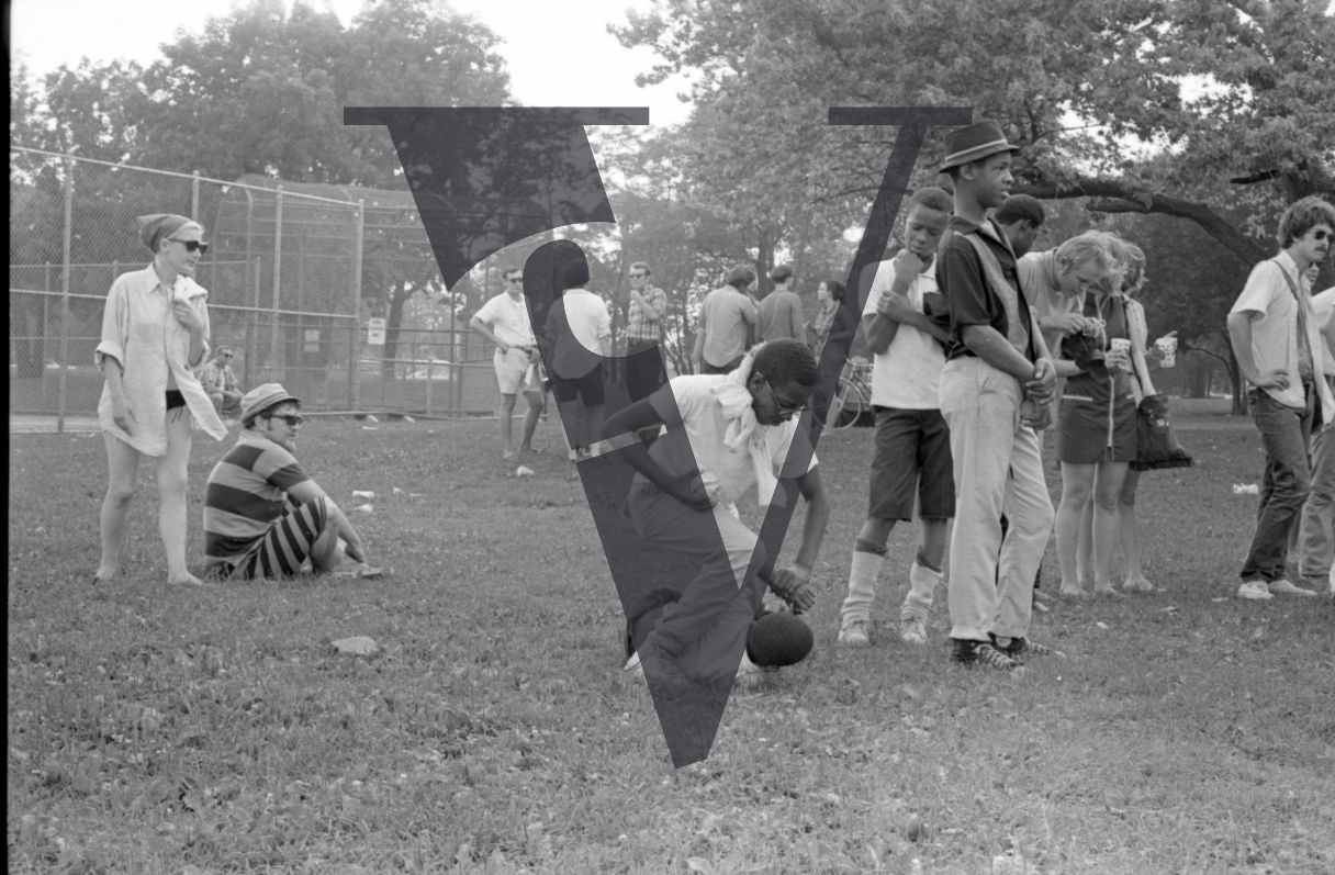 Chicago, Anti-war rallies in Lincoln Park, children play wrestling in park.