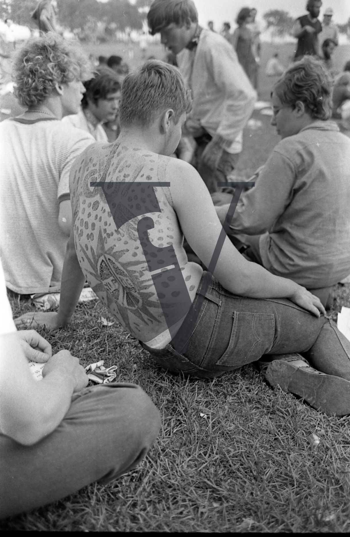 Chicago, Anti-war rallies in Lincoln Park, shot of man with full back tattoo reads Yippie.