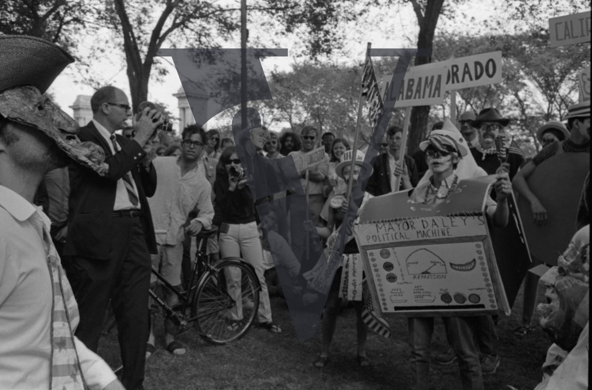 Chicago, Anti-war rallies in Lincoln Park, protesters in costumes and facepaint with placards about Mayor Daley.