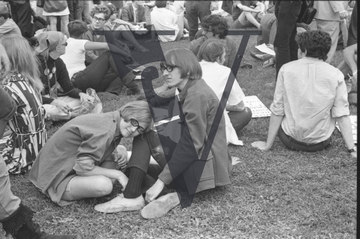 Chicago, Anti-war rallies in Lincoln Park, hippy youth in glasses sit on the grass.