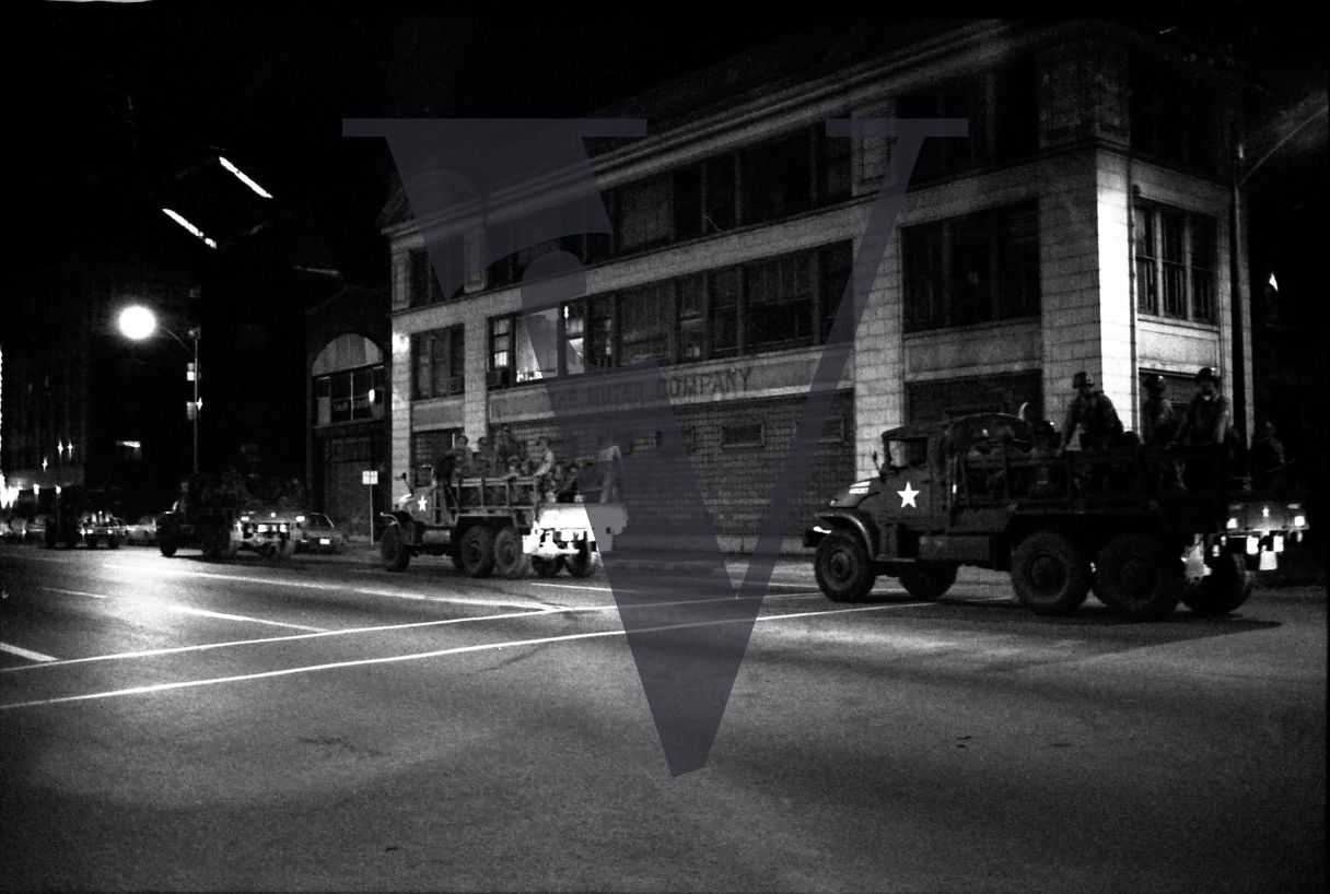 Chicago, Anti-war rallies in Lincoln Park, armed military vehicles outisde The Muter Company warehouse, night-time.