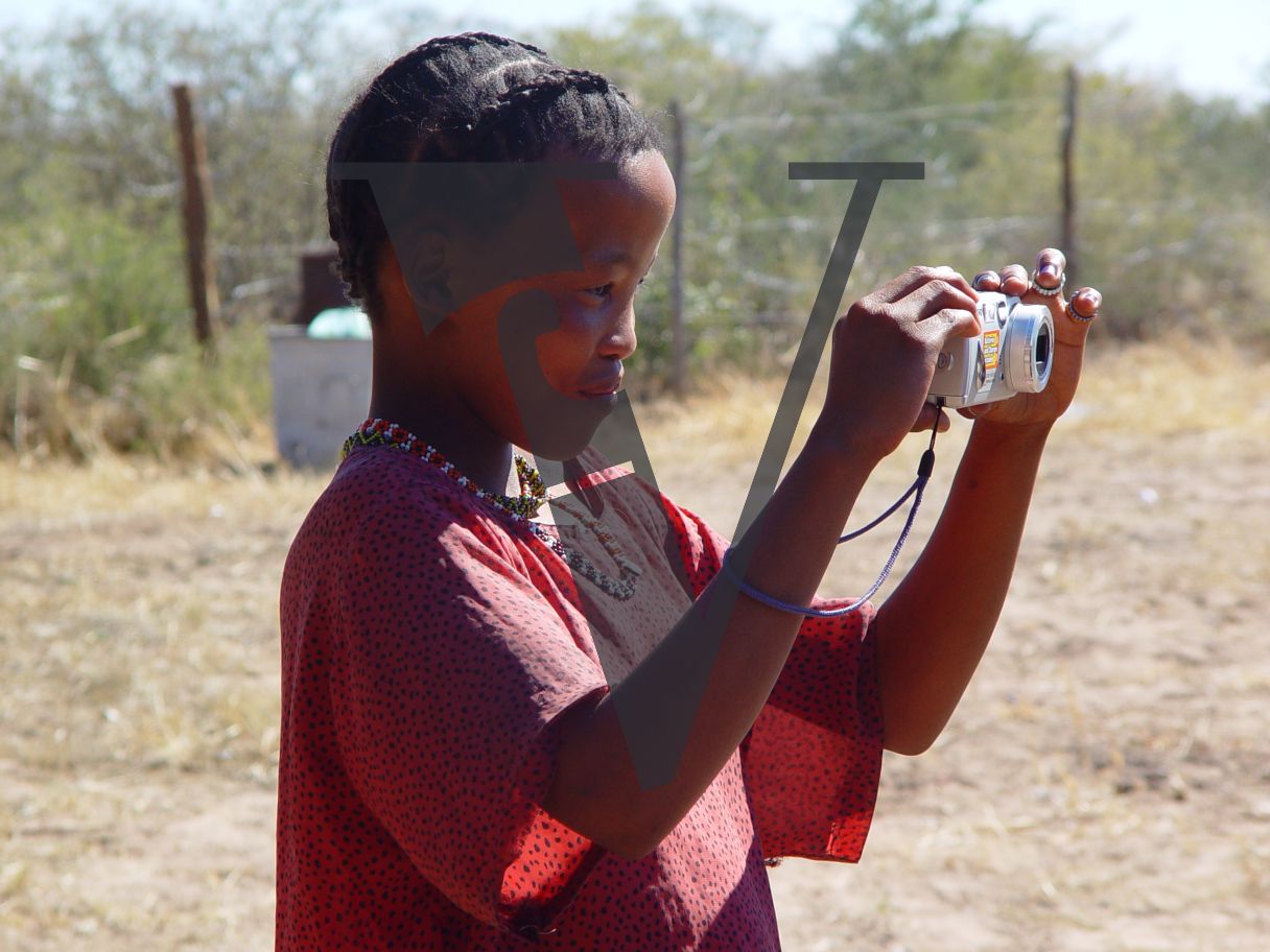 N!Xau, the “Bushman”, child with digital camera.