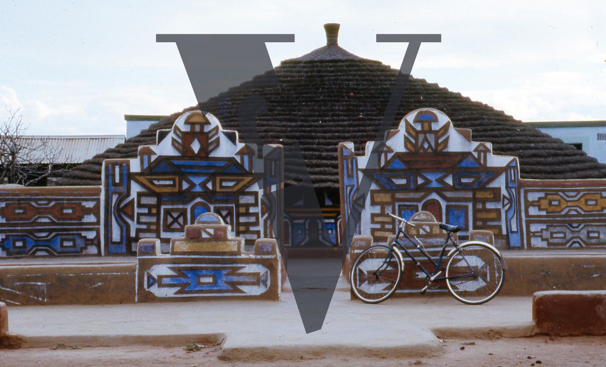 South Africa, Ndebele village, walls and facade of painted house, bicycle.