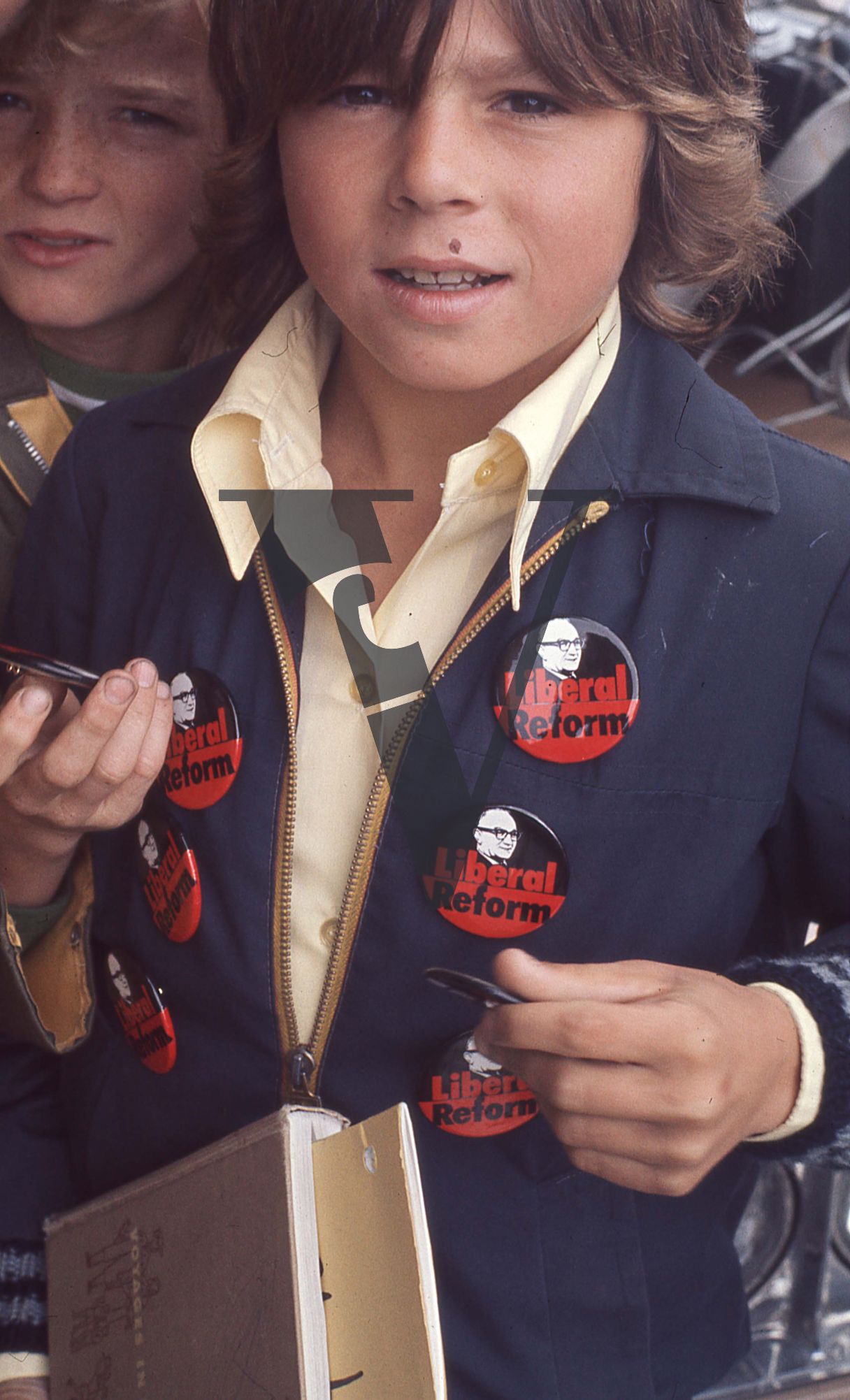 Newfoundland, Boy has many Joey Smallwood campaign buttons on blue jacket.