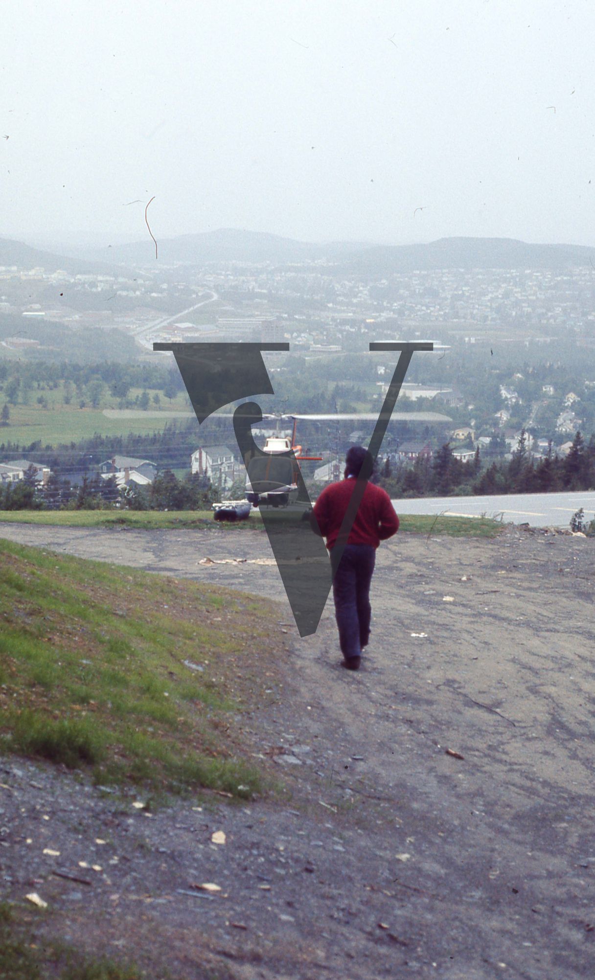 Newfoundland, St. Johns, capital city, man walking to a helicopter.