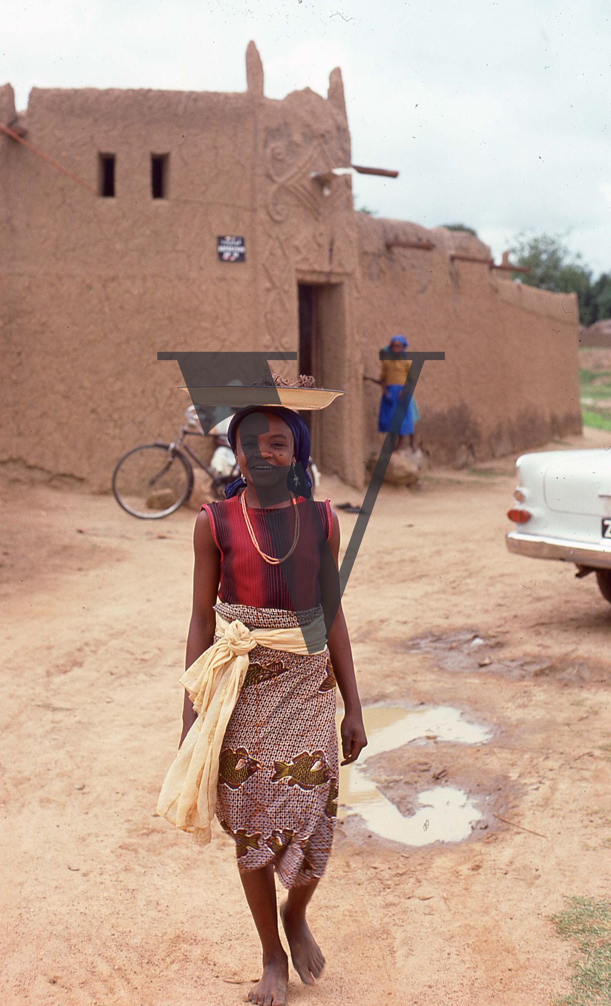 Nigeria, girl with a plate on her head.