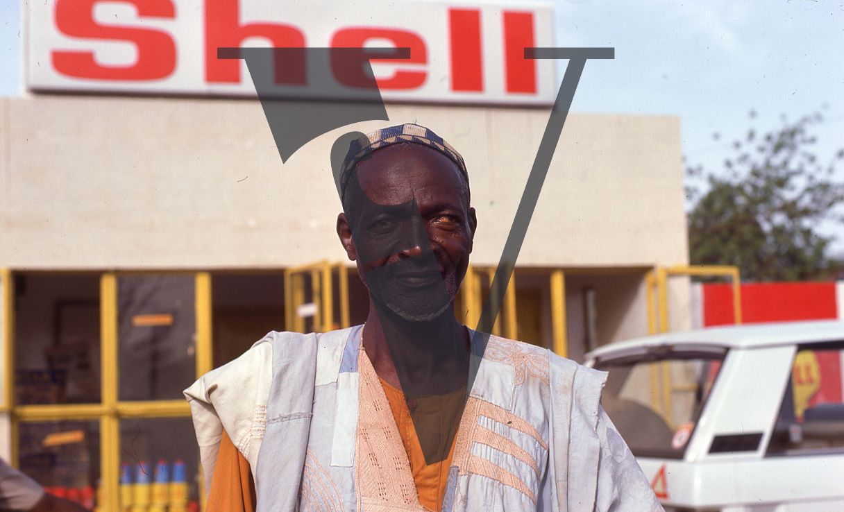 Nigeria, man outside Shell gas station, portrait.