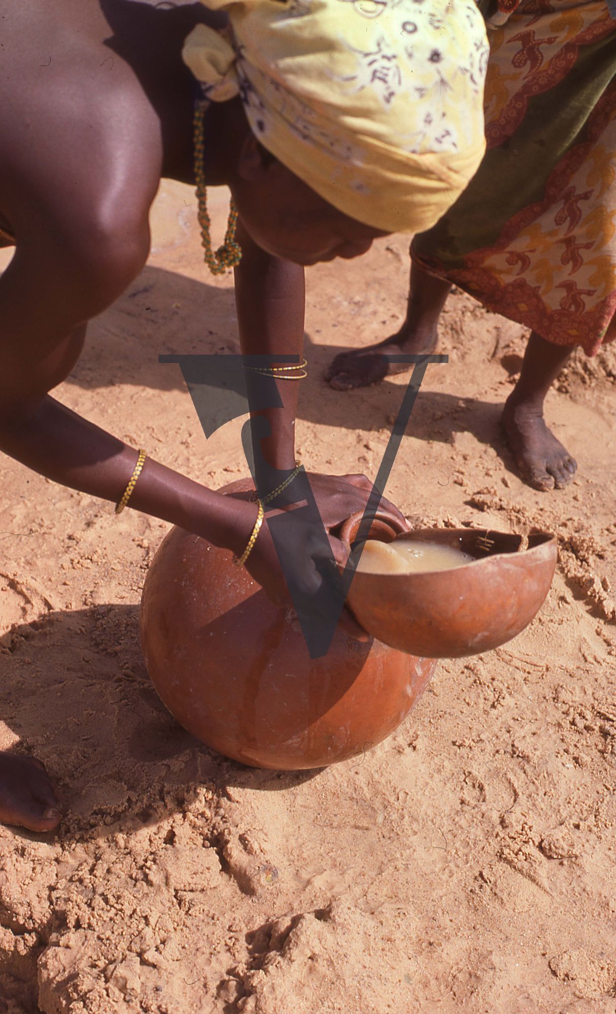 Nigeria, woman pouring from calabash.
