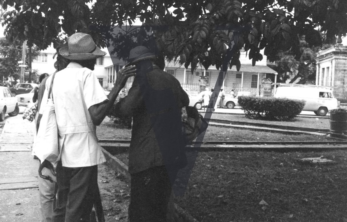 Barbados, street scene, elderly men talking to each other.