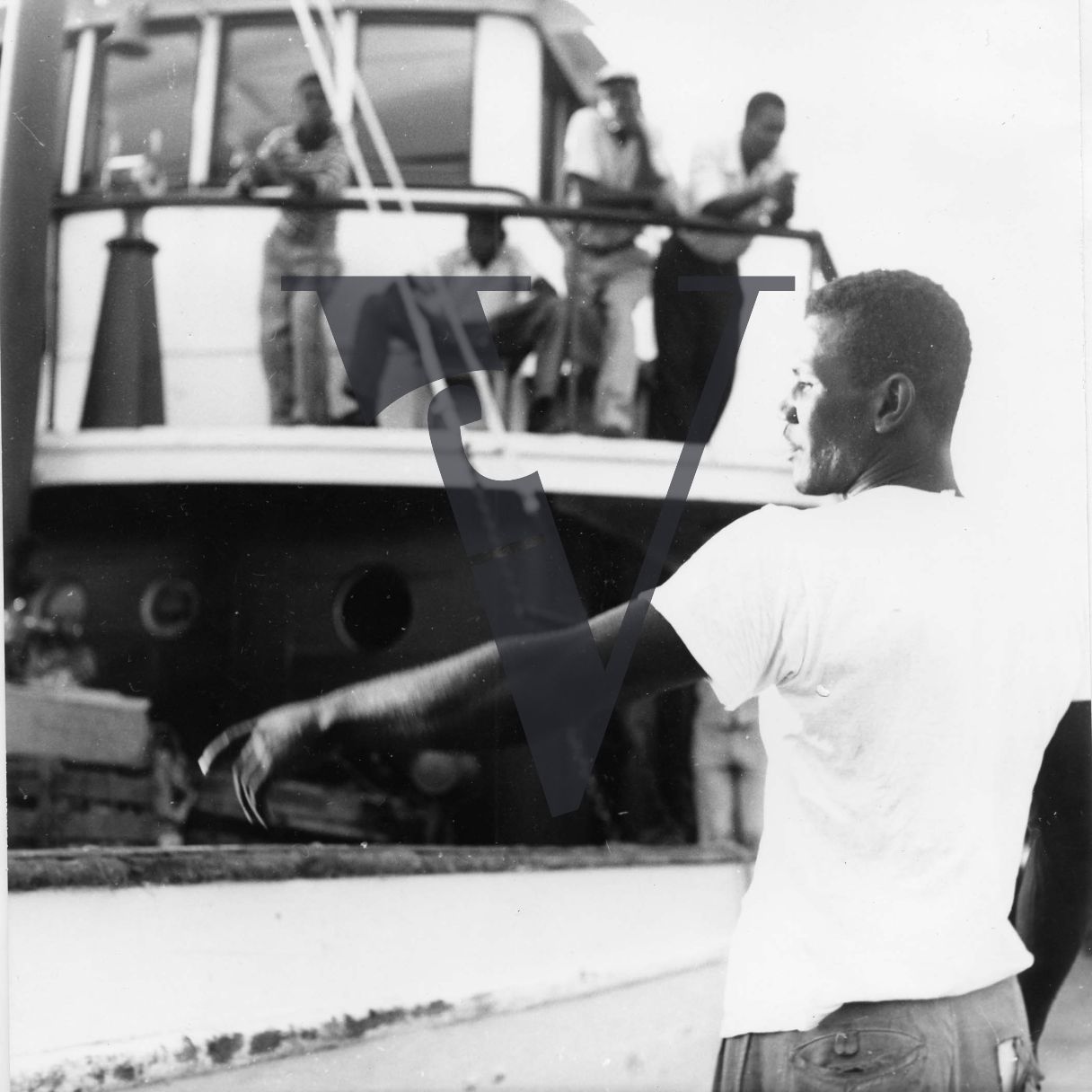 Belize, harbour, fishing boat, man pointing.