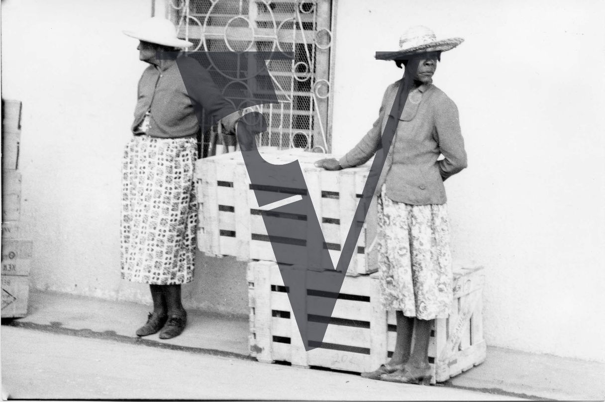 Belize, people, two women wait outside.
