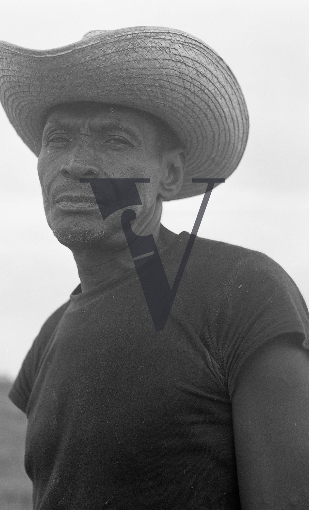Belize, Portrait, man in large straw hat, t-shirt.