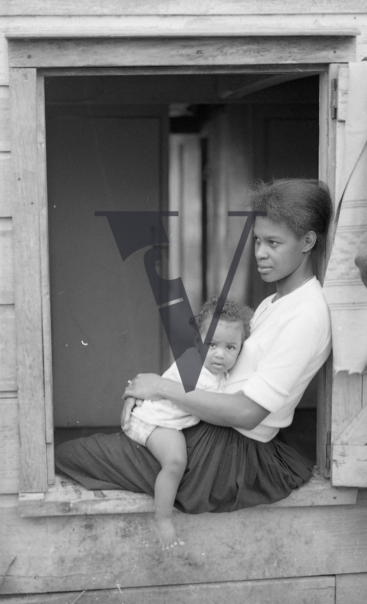 Belize, Portrait, mother and daughter in windowsill.