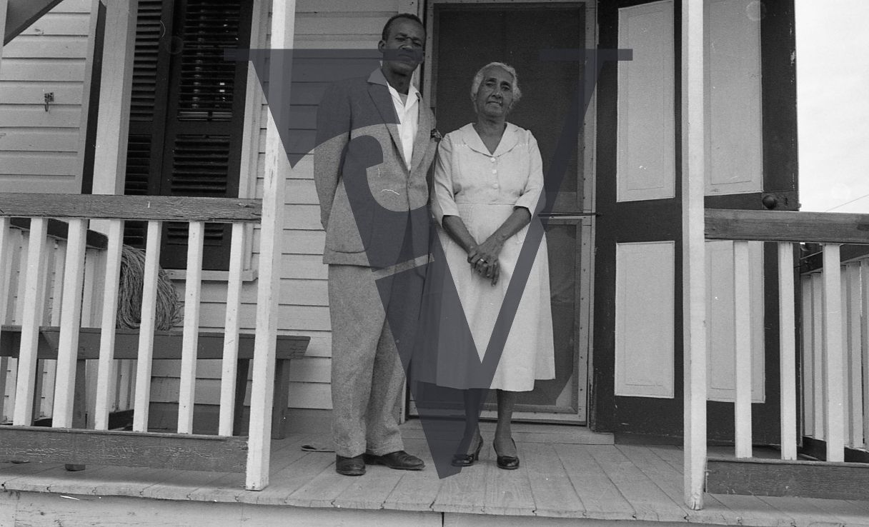 Belize, Portrait, man and woman pose on porrch, dressed up.
