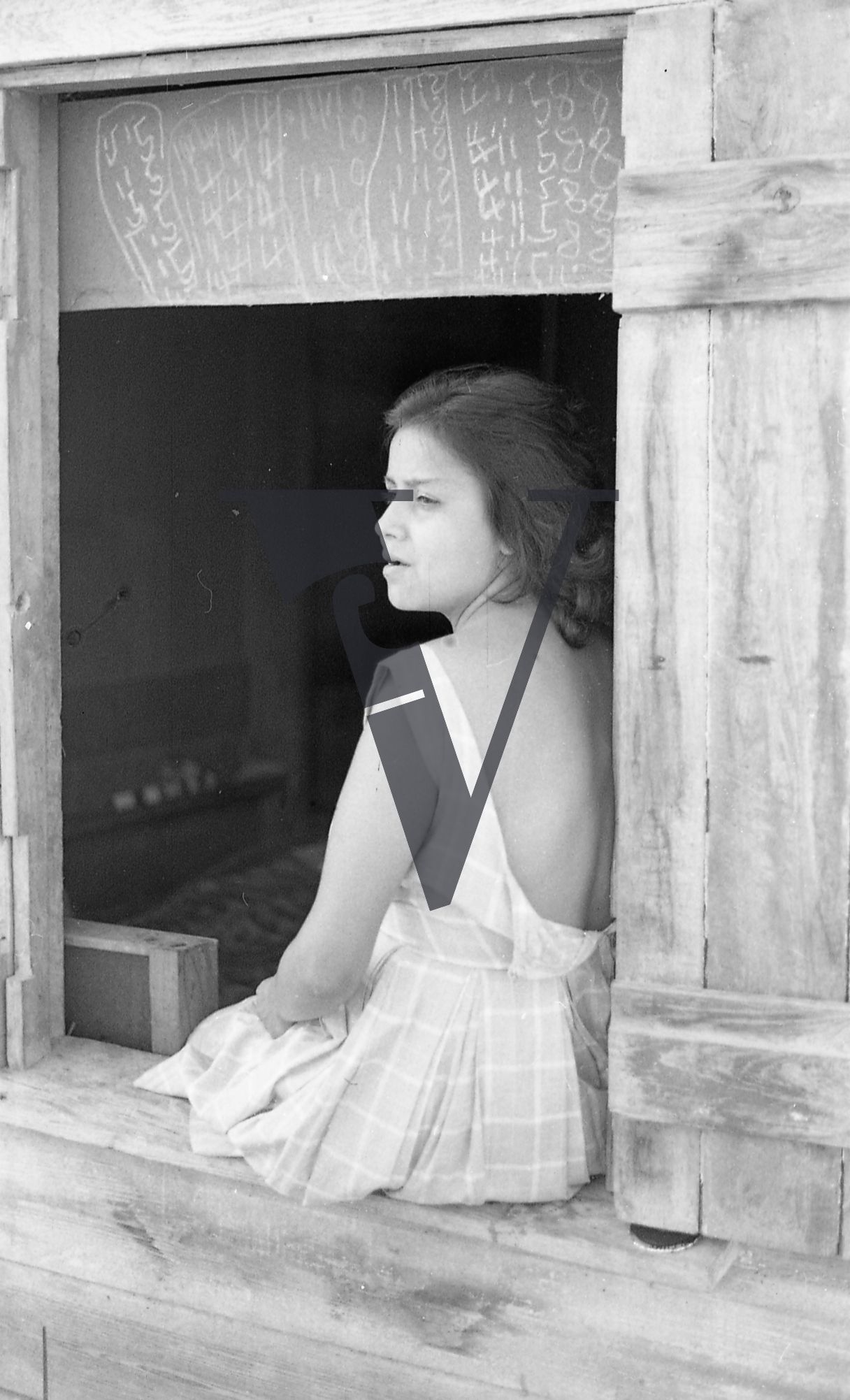 Belize, Portrait, woman looks out from windowsill.
