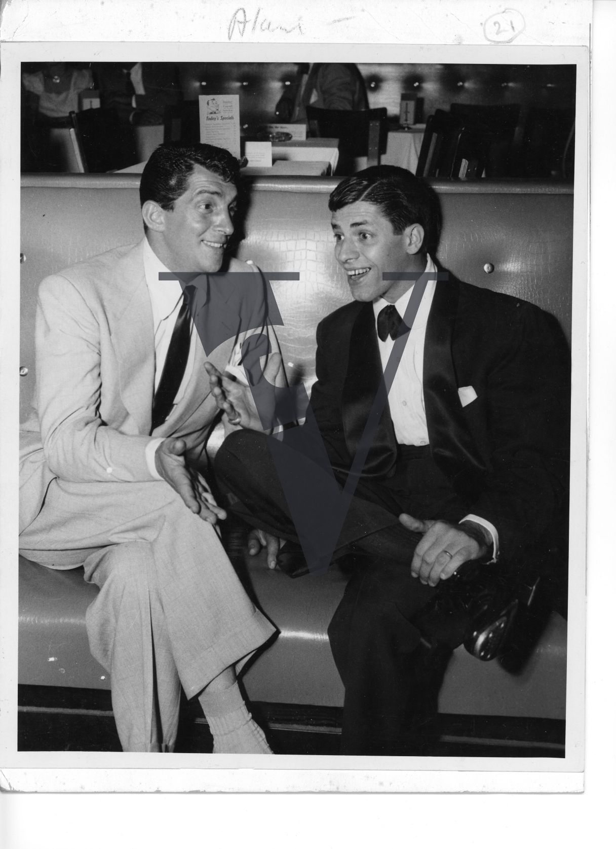 Dean Martin and Jerry Lewis, seated, portrait, full shot.