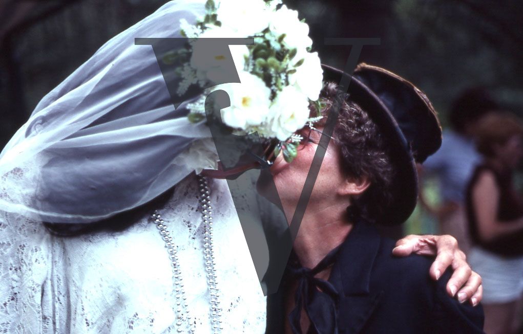 Sackett Lake, Laurels Hotel, mock wedding, male “bride” with pig’s snout kissing female “groom”, mid-shot.