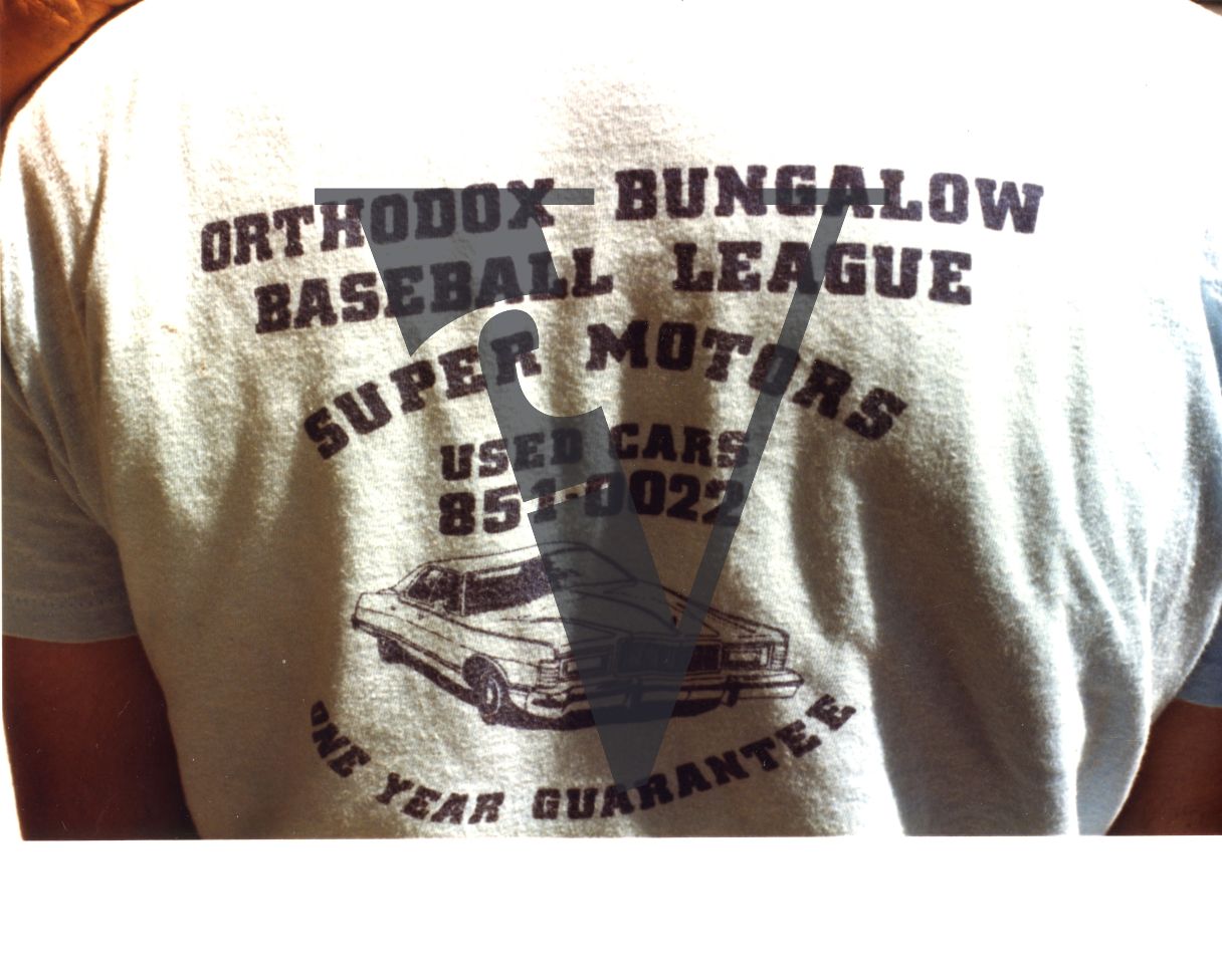 Orthodox Bungalow Baseball League t-shirt, Super Motors Used Cards sponsor, close-up.