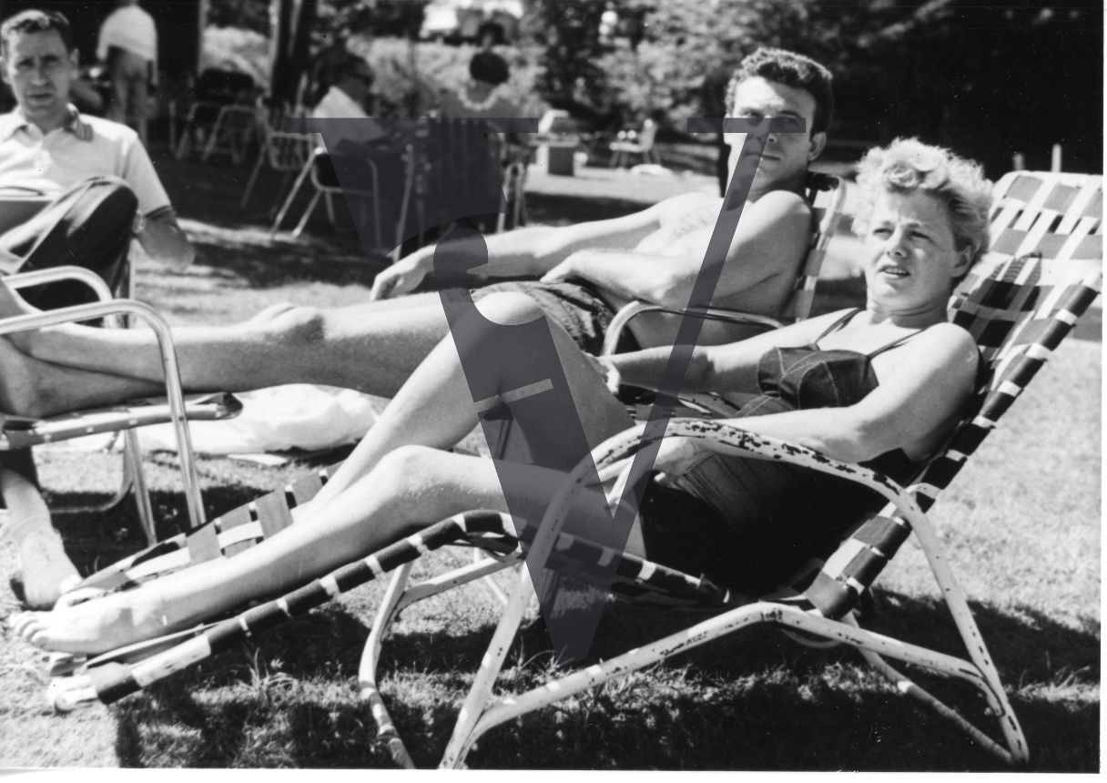 Shelley Winters and Tony Franciosa, actors, reclining at Lou Goldstein's Simon Says, full shot.