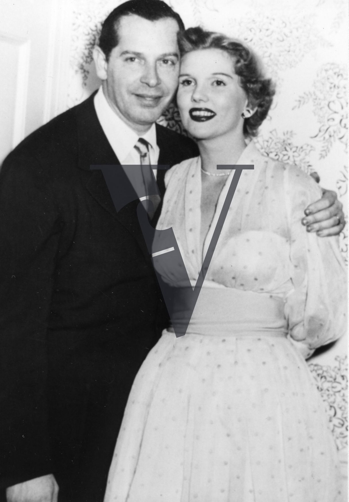 Milton Berle with woman, actor, comedian, Golden Age of Television, portrait, mid-shot.