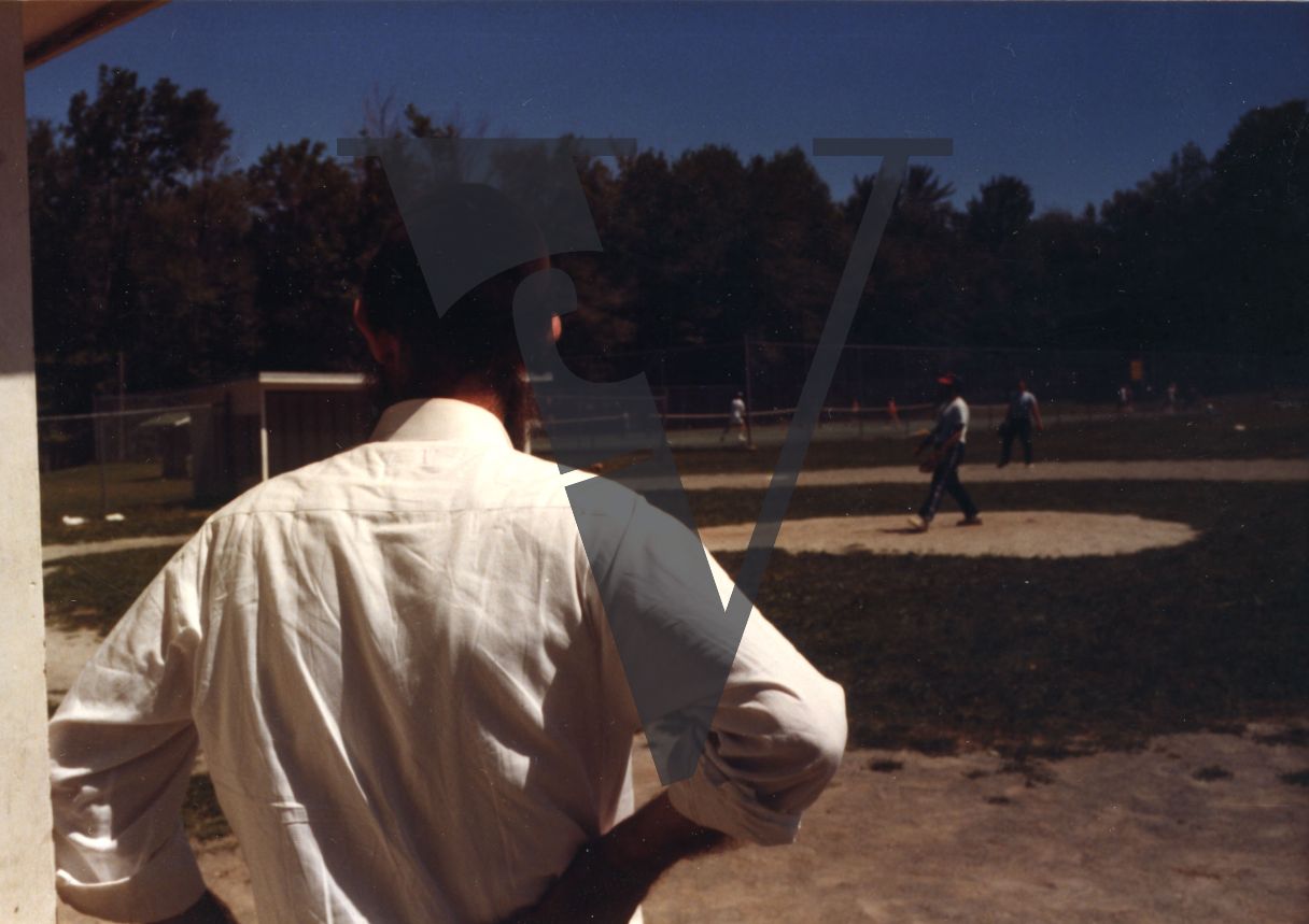 Orthodox Jews playing baseball, Hasidic, mid-shot from rear.