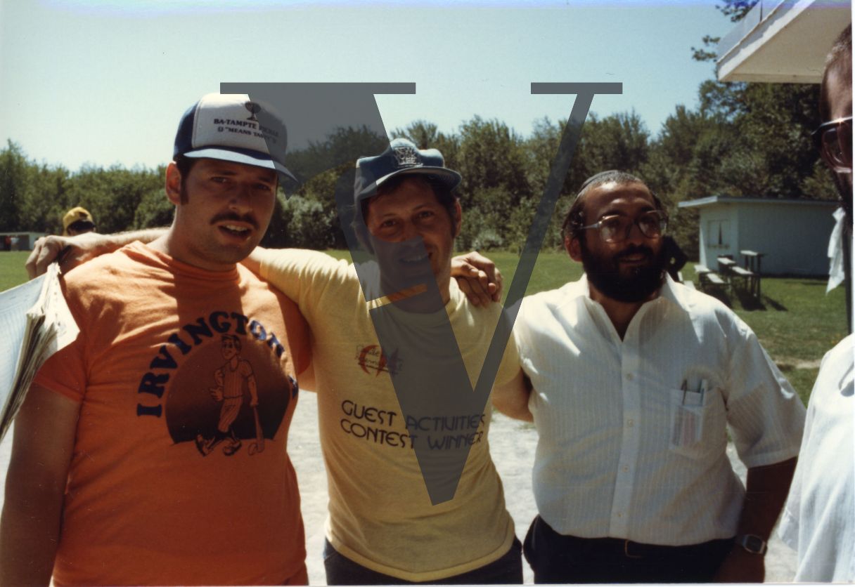 Orthodox Jews playing baseball, Hasidic, Ba-Tampte Pickle snapback cap, smiling, portrait, mid-shot.