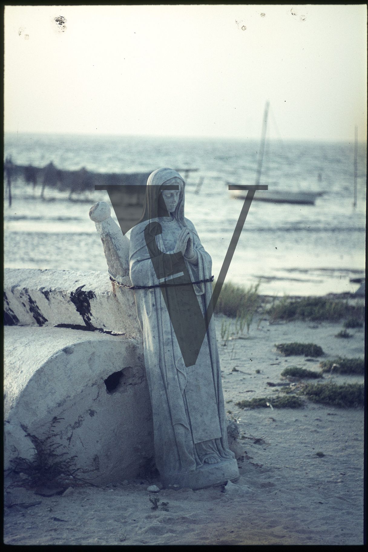 Belize, Virgin Mary statue stands on the beach, after Hurricane Hattie.