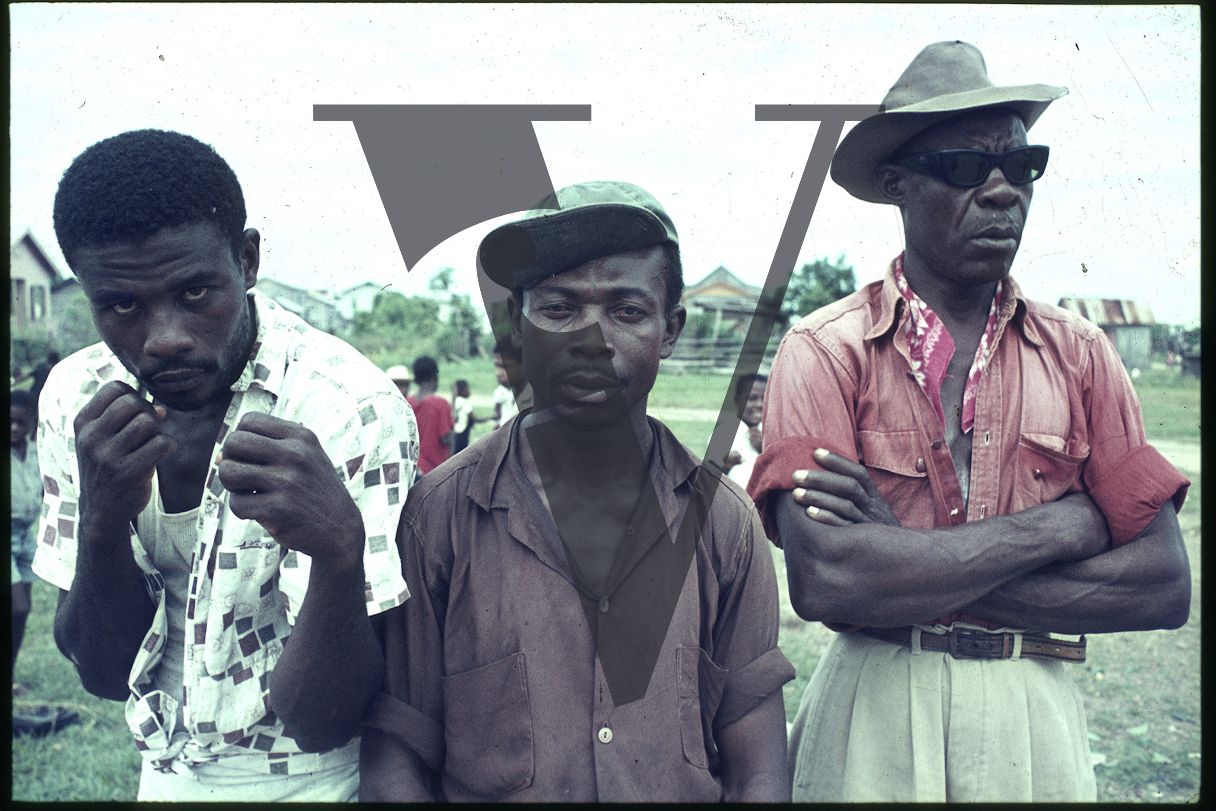 Belize, Three men pose for camera.