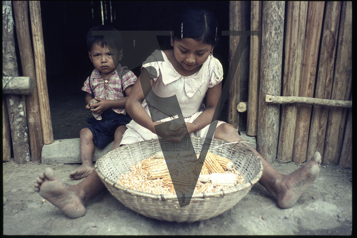 Belize, Children prepare corn, Kekchi.
