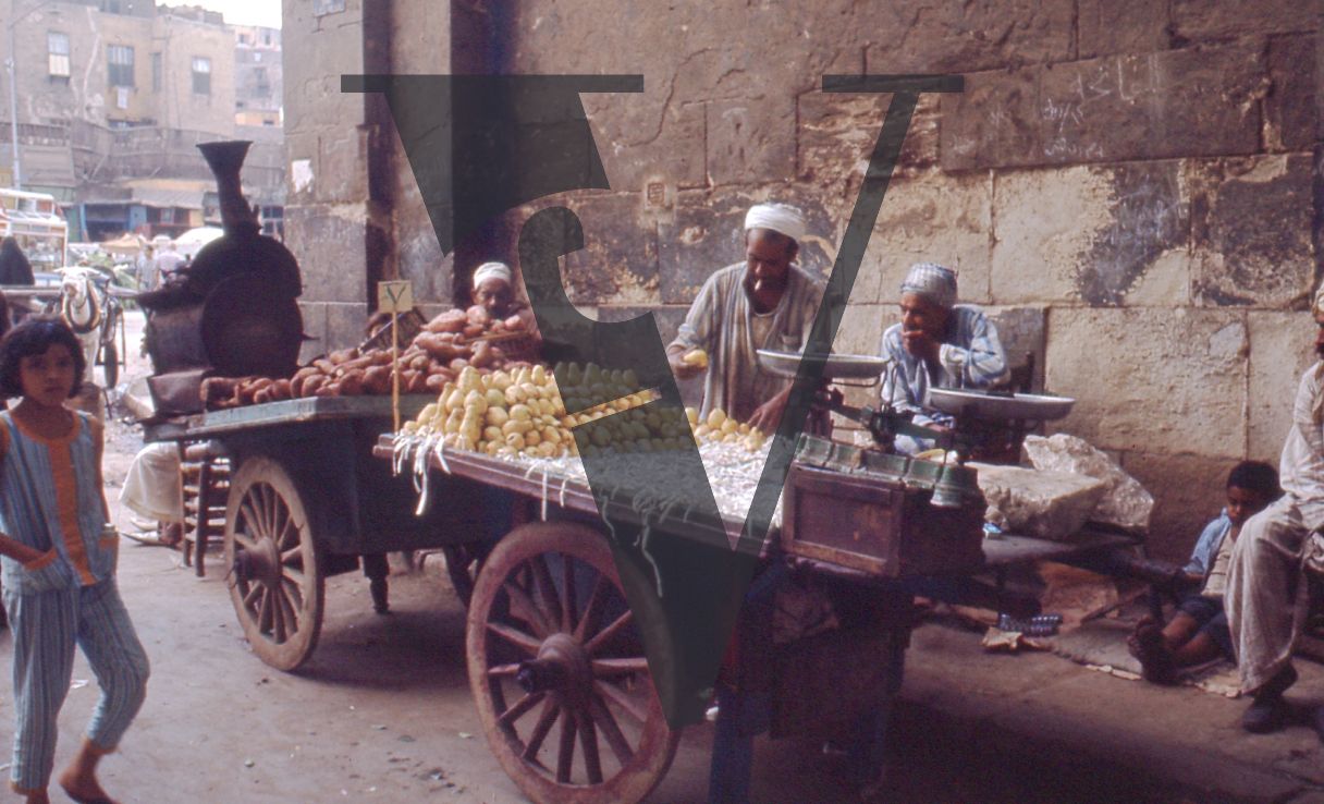 Egypt, Alexandria, street scene, fruit traders and children.