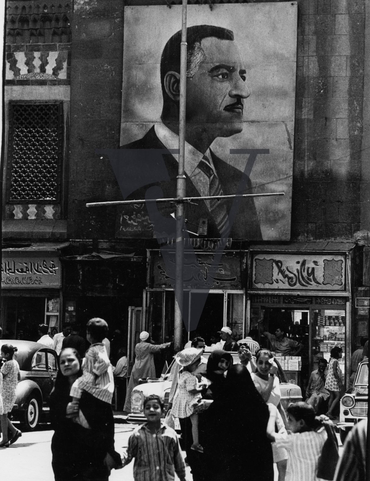 Egypt, street scene, cars, Nasser billboard.