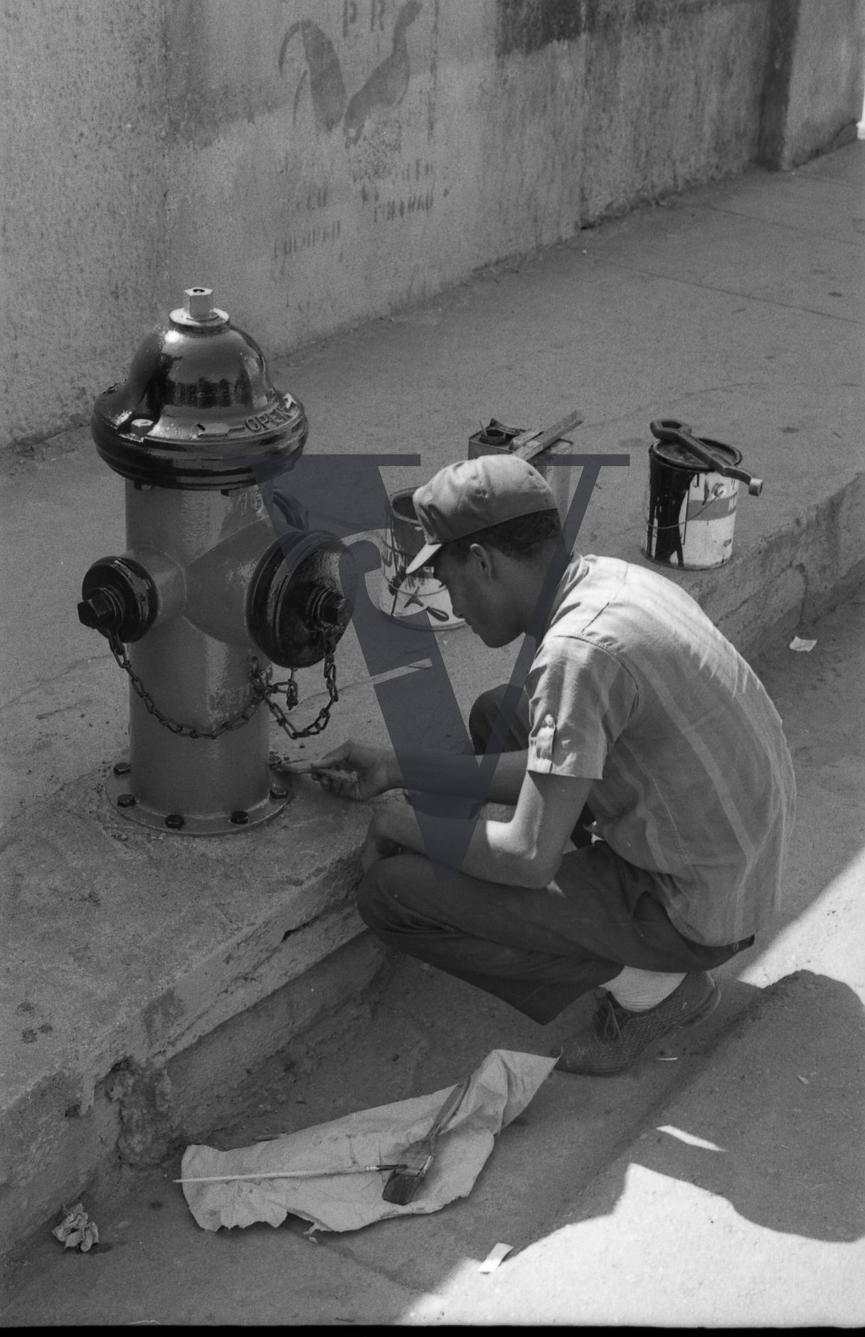 Dominican Republic, man fixing street water fountain.