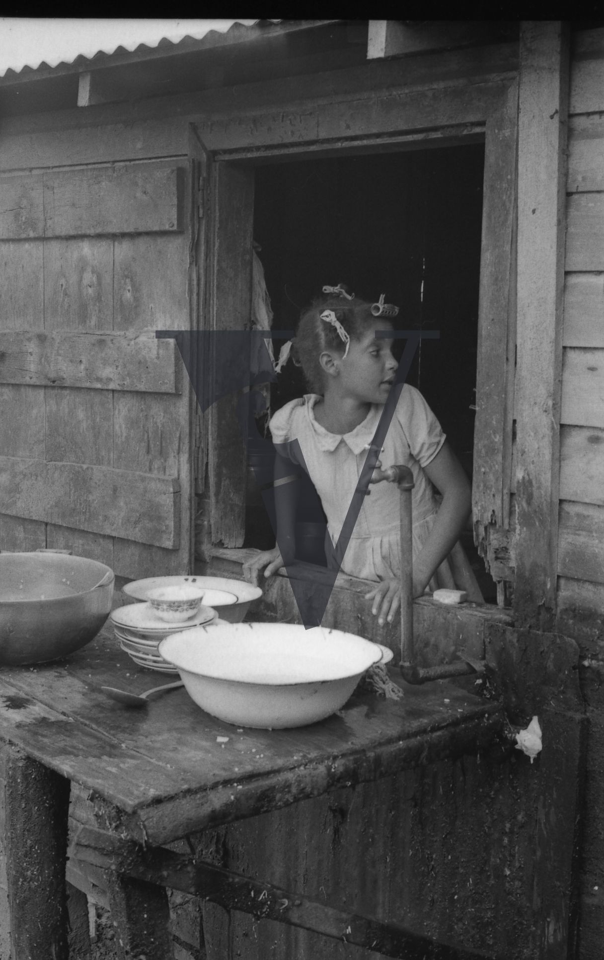 Dominican Republic, girl washing pots.