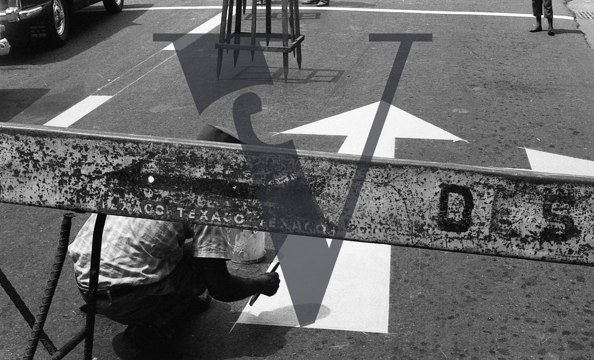 Dominican Republic, man painting road sign.