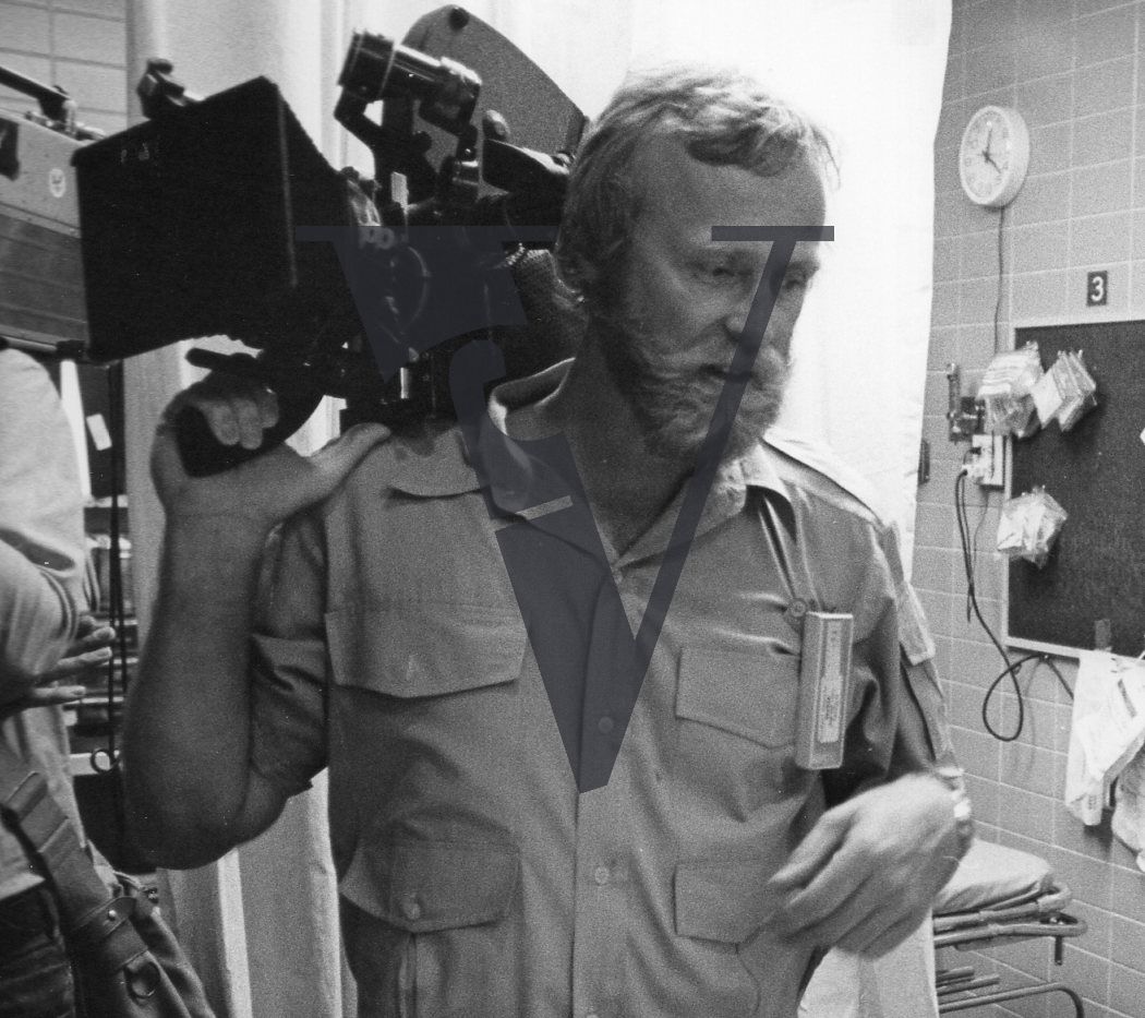 Robert Elfstrom, camera on shoulder.