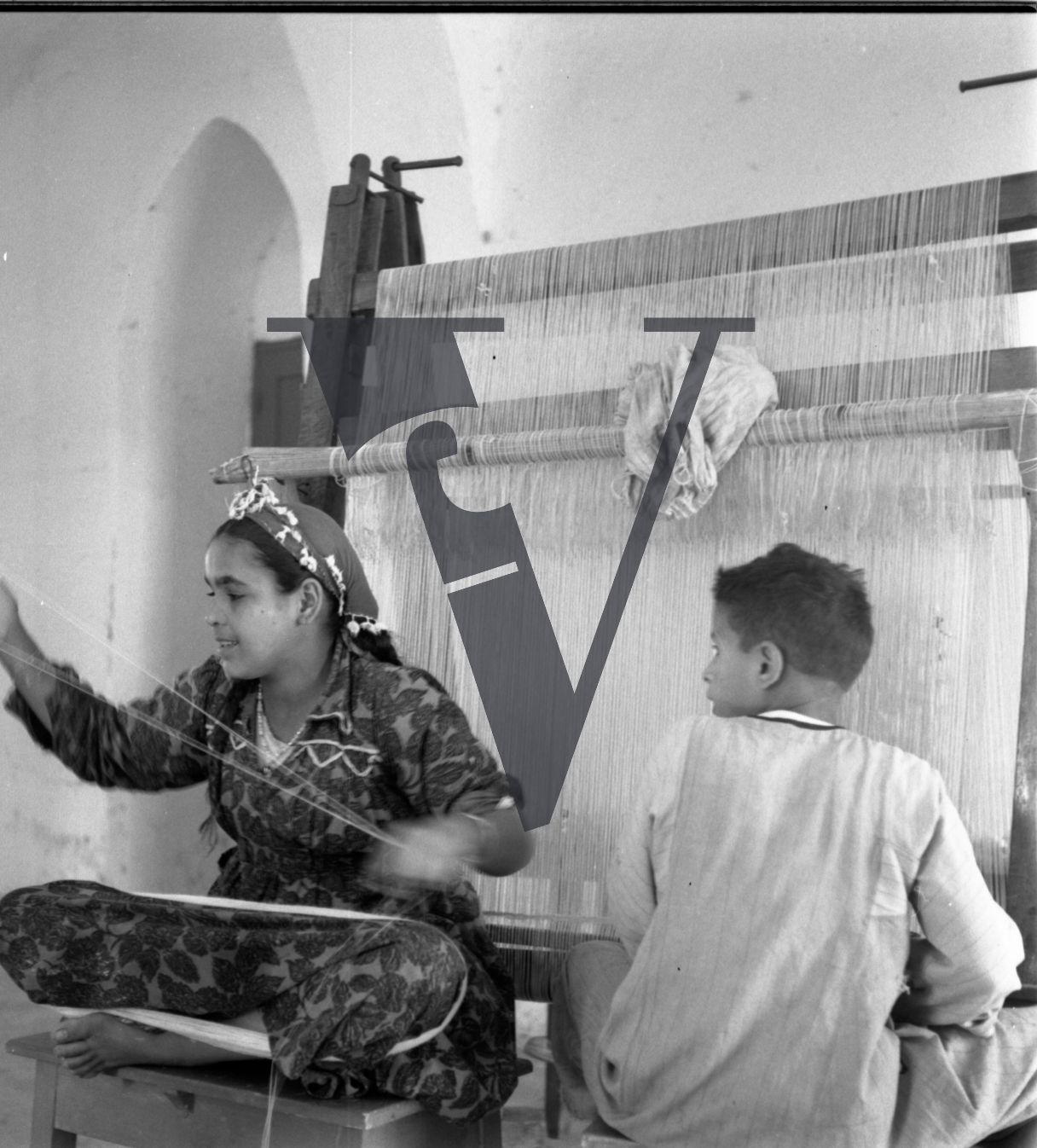 Harrania, Egypt, children on looms weaving.