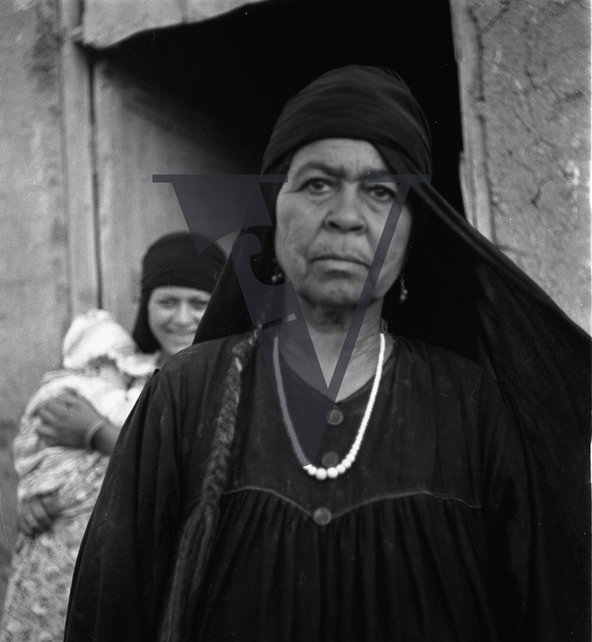 Harrania, Egypt, woman stares at camera.